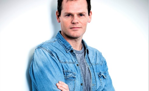 headshot of Luca Silvestrini. White male crossed arms looking at the camera with denim shirt