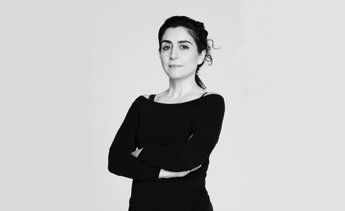 black and white headshot of Xenia Aidonopoulou. Female dancer with arms crossed
