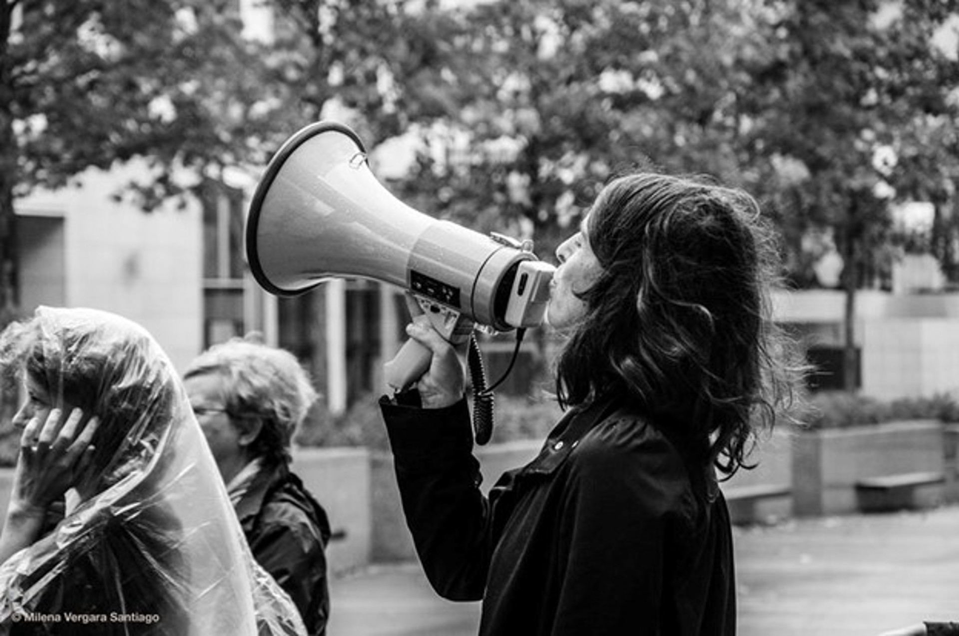 Black and white image of a person using a megaphone Black and white image of a person using a megaphone