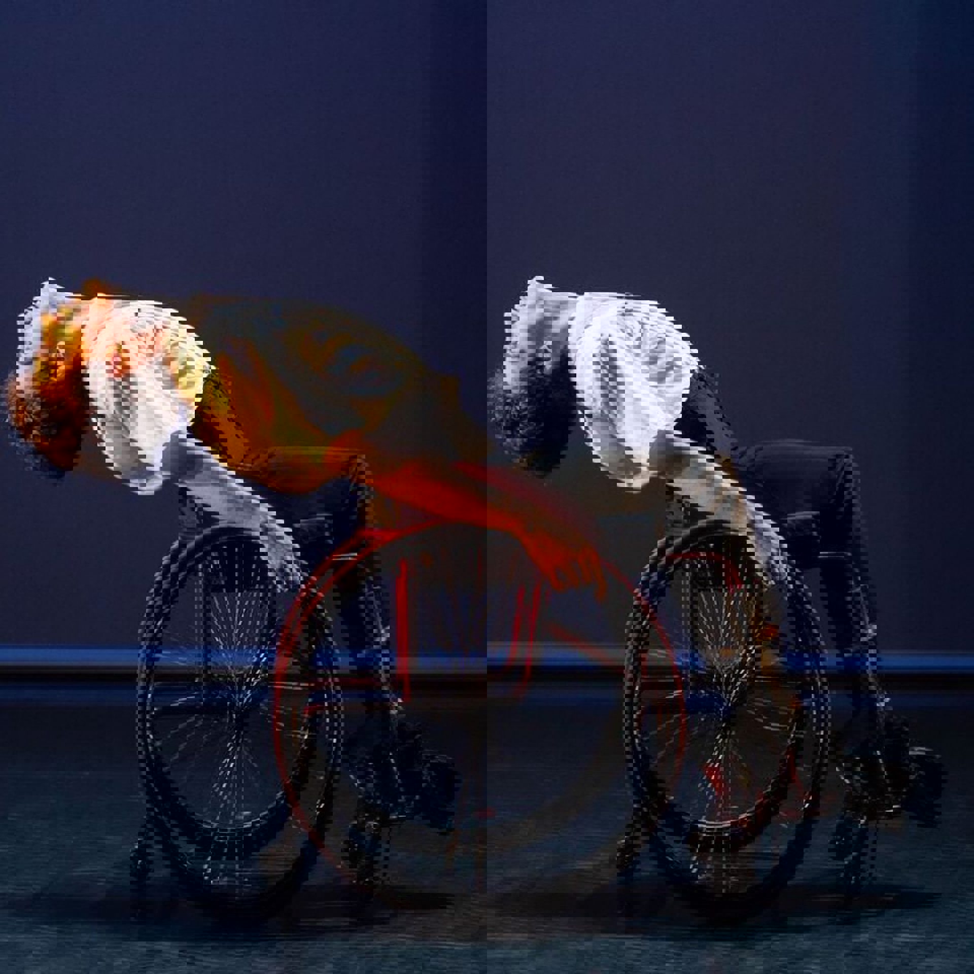 white male in a wheel chair bending backwards on a stage white male in a wheel chair bending backwards on a stage