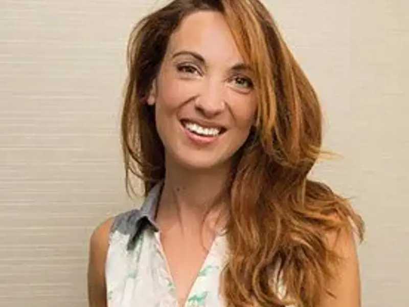 Headshot of Laura Colomban. Female smiling at the camera with long reddish blonde hair. Wearing white shirt. Headshot of Laura Colomban. Female smiling at the camera with long reddish blonde hair. Wearing white shirt.