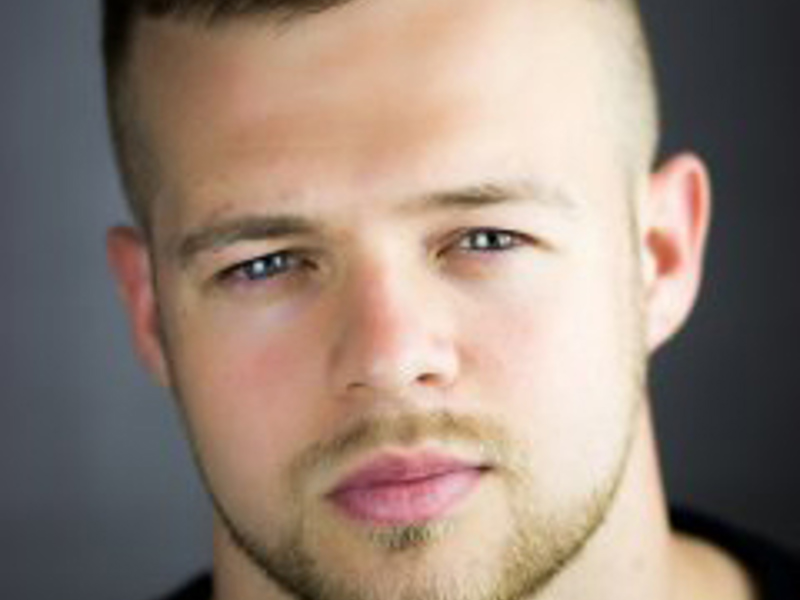 Headshot of Lindon Barr. Short haired white male with a short stubble looking at the camera. 