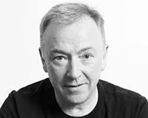 Headshot of Andrew Carrick. Black and white headshot of male with short hair wearing a black t-shirt.