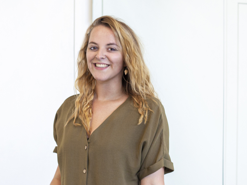 Headshot of Dani Bower. white female with long blond curly hair smiling at the camera