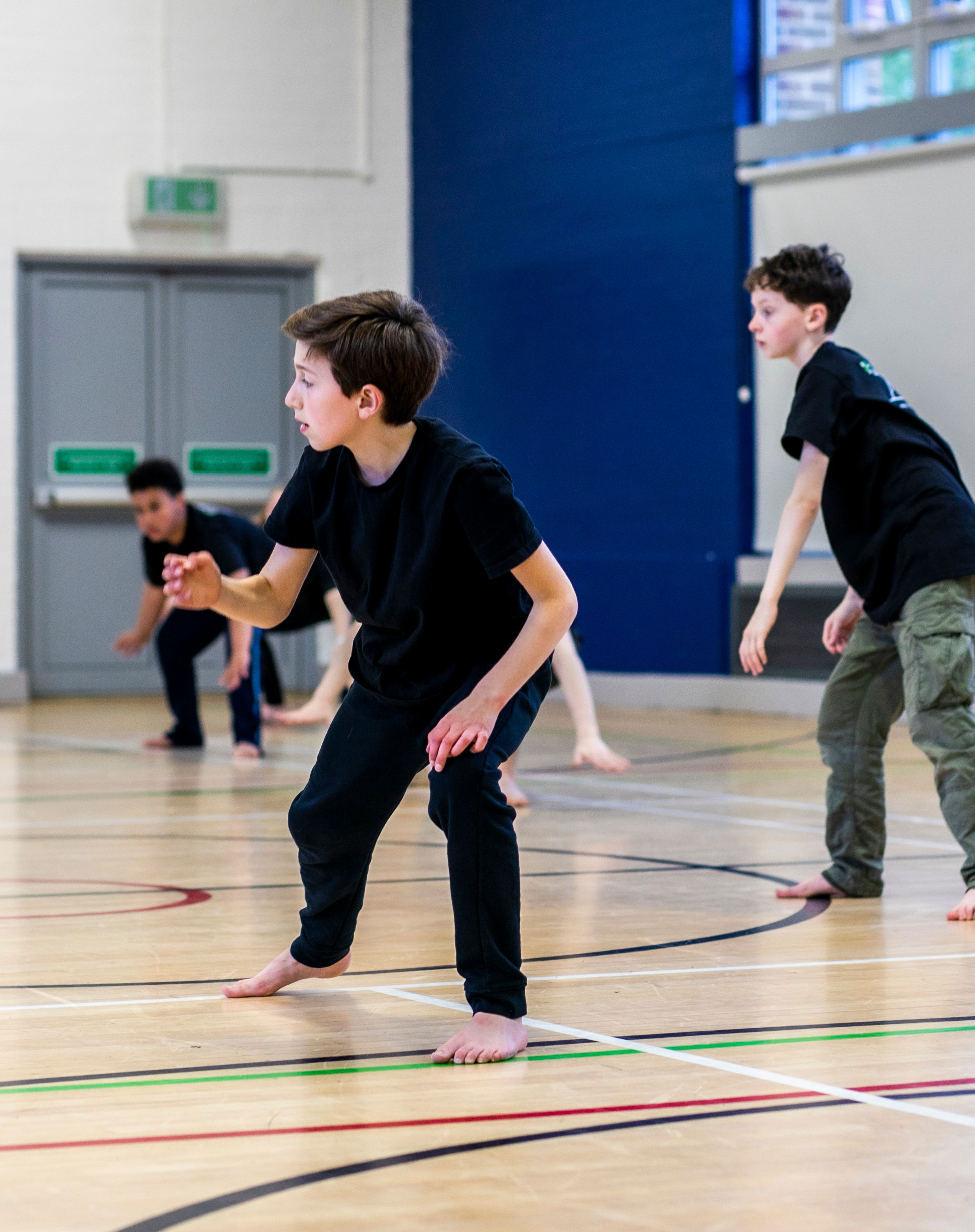 Three young boys dancing in a sports hall Three young boys dancing in a sports hall